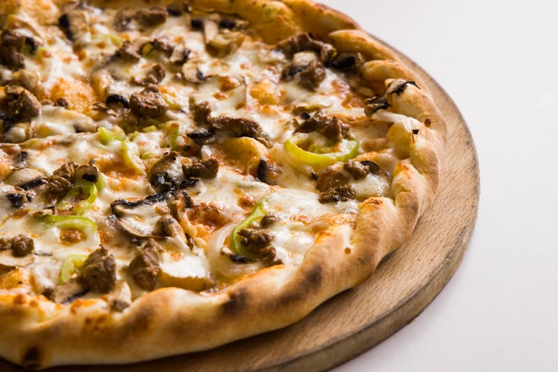 Lucy Sunshine bright veggie mod pizza with peppers and mushrooms