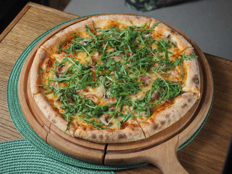 The Magnolia elegant white mods pizza with prosciutto and arugula